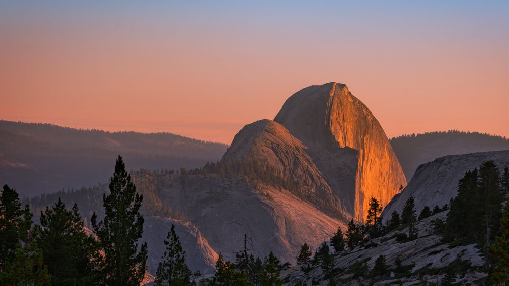 Half Dome in Yosemite National Park glowing in warm evening light, photographed from Olmsted Point.