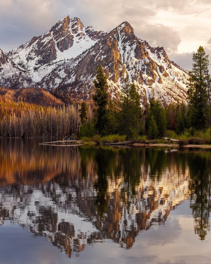McGowan Peak at sunset, reflected in the calm waters of Stanley Lake in Idaho’s Sawtooth Mountains.