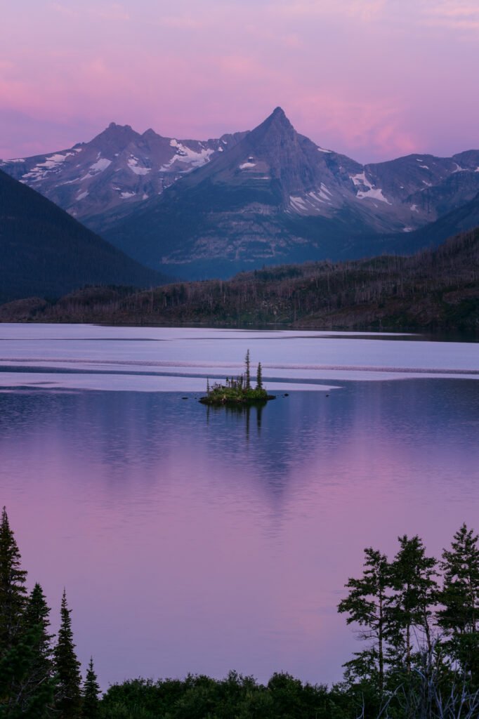 Wild Goose Island in Saint Mary Lake at blue hour, with magenta skies reflected in the calm water of
Glacier National Park